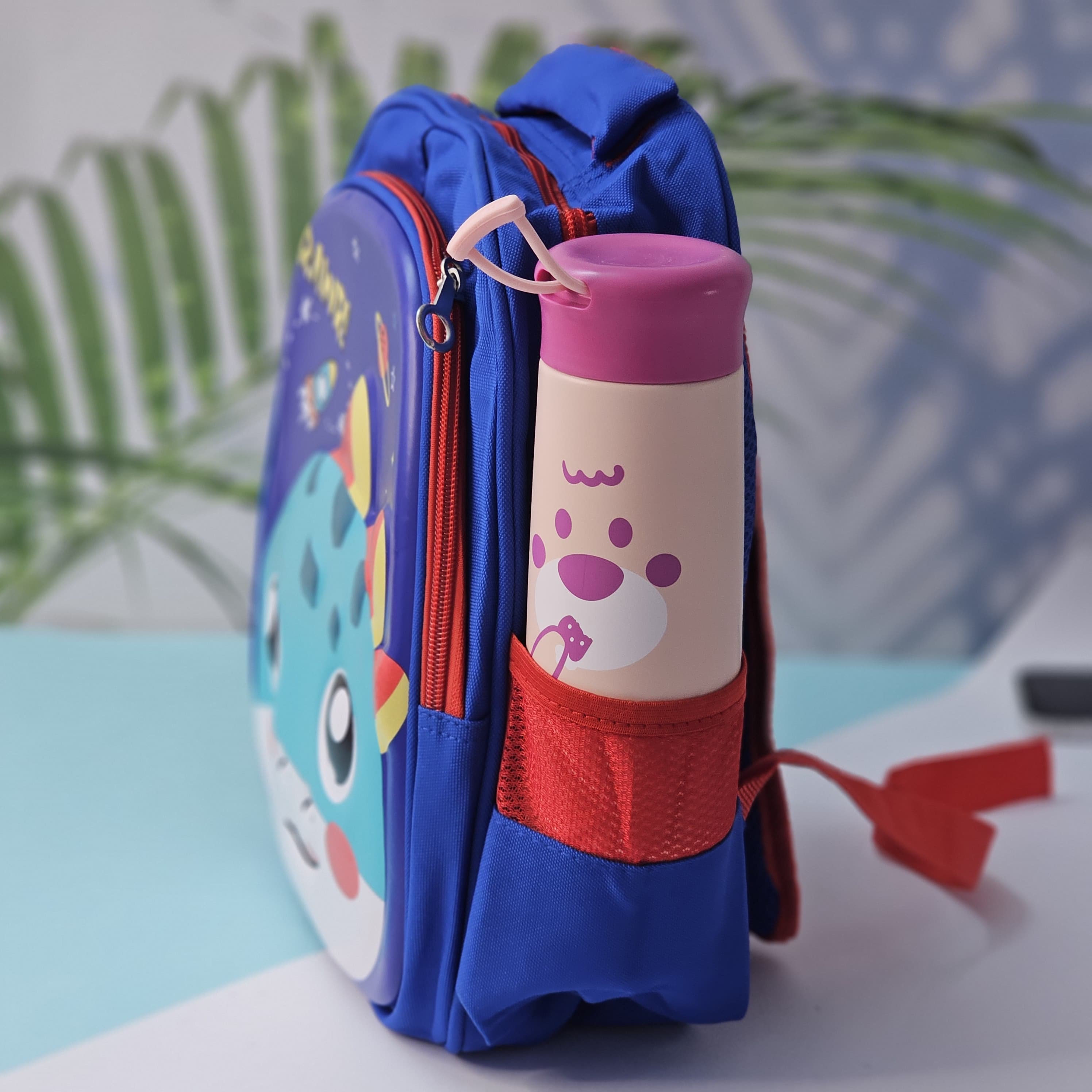 Pink cartoon school backpack for children by Usmile Toys, featuring a cute unicorn face with a rainbow horn and a side pocket for a water bottle." www.usmile.toys